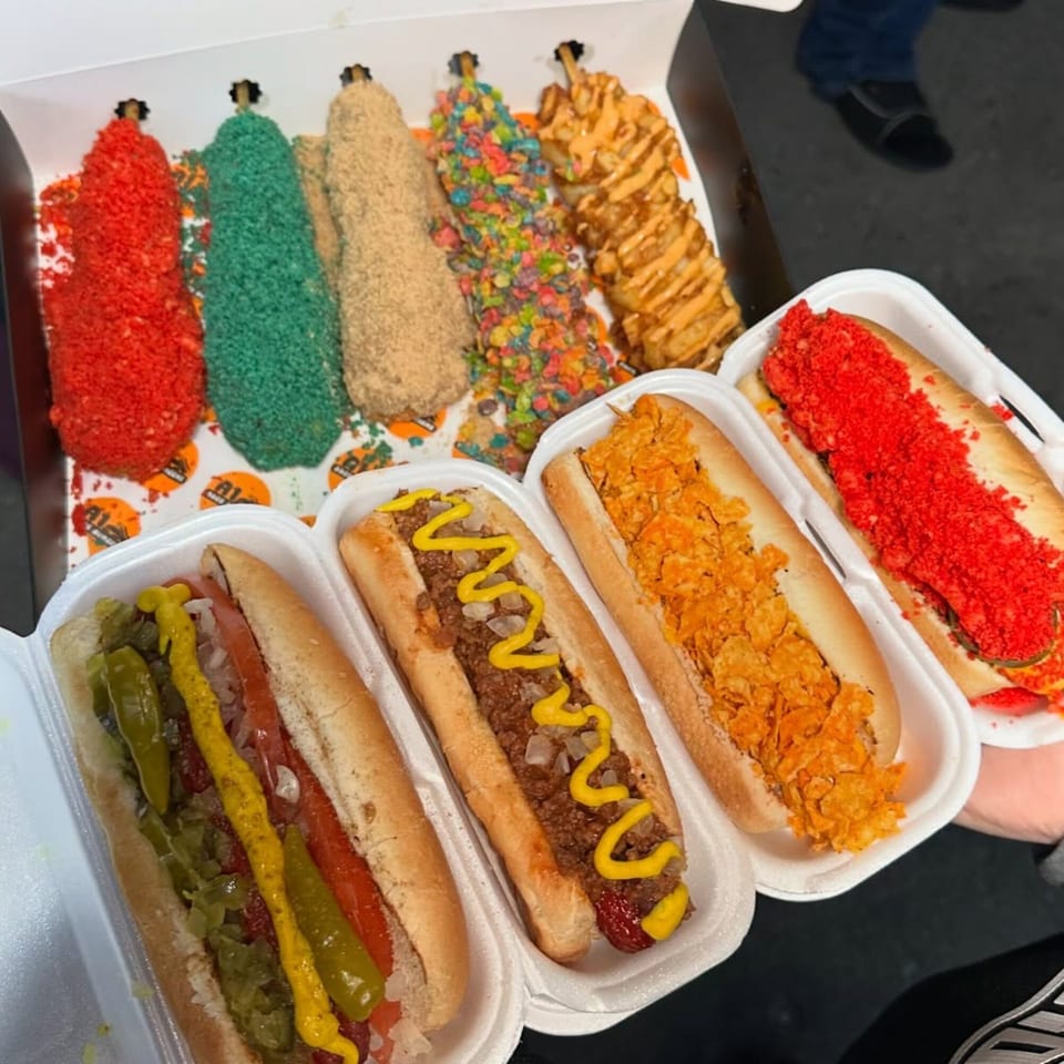 A variety of Tee's A1 Dogs hot dogs and corn dogs with colorful, unique toppings.